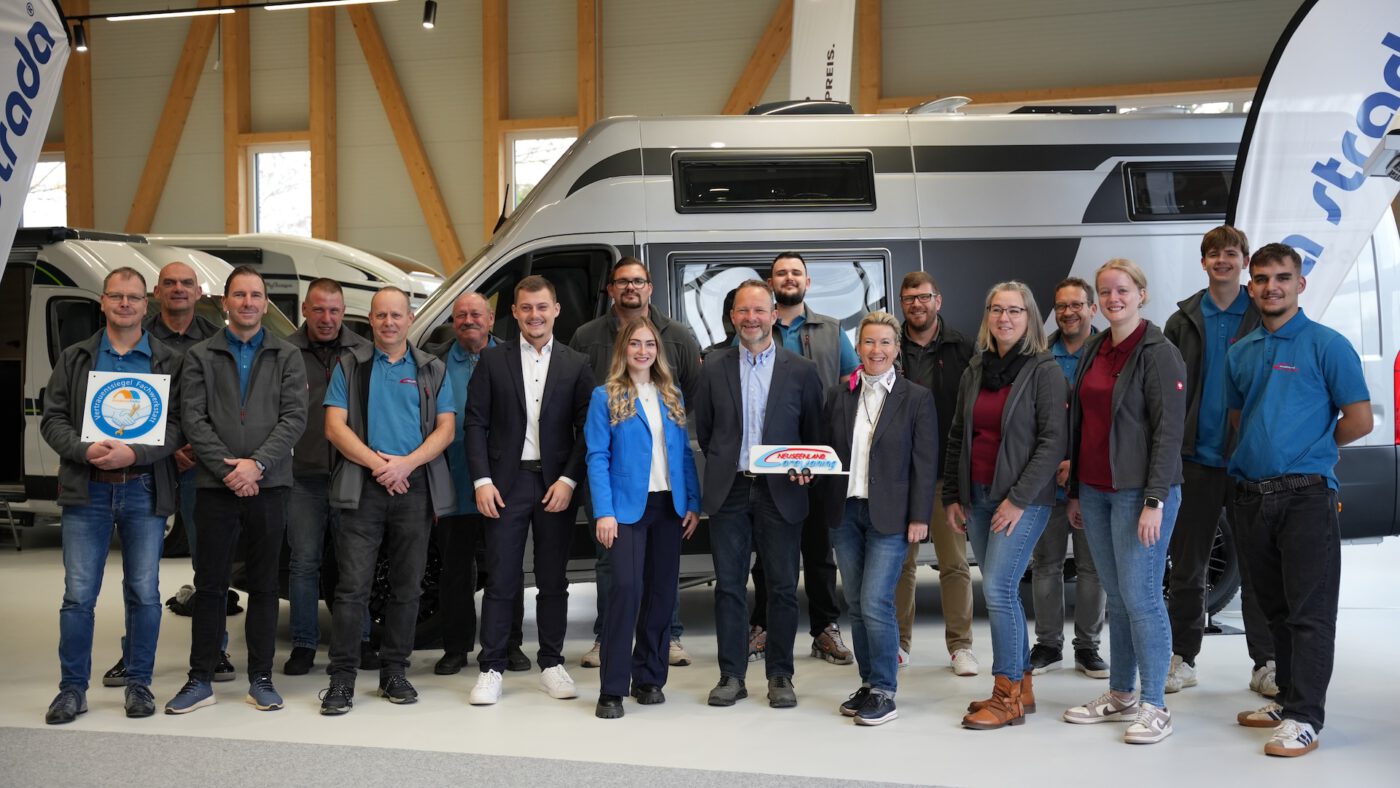 Das gesamte Team von Neuseenland Caravaning im vor einem Fahrzeug im Neubau